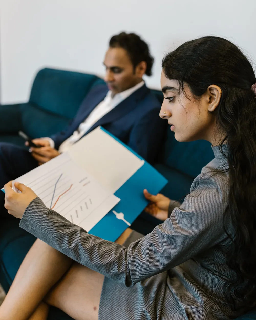 Two professionals reviewing financial charts